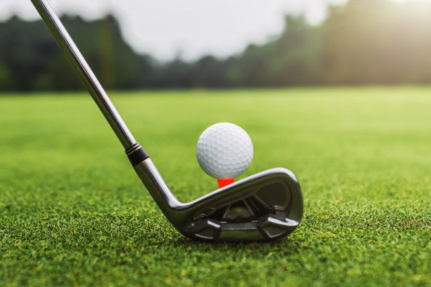 image of a golf ball on tee with a golf club about to hit it
